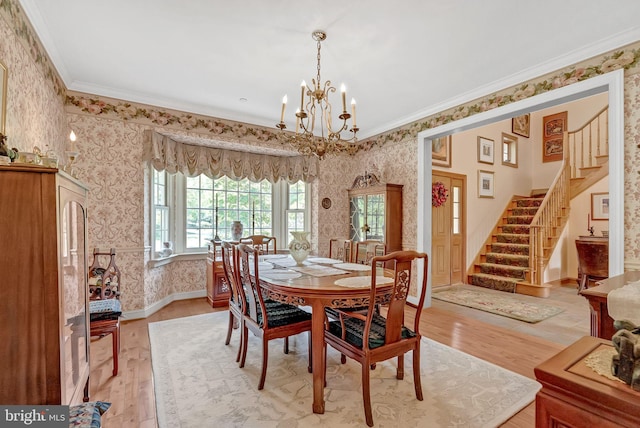 dining area with hardwood / wood-style floors, a chandelier, and ornamental molding