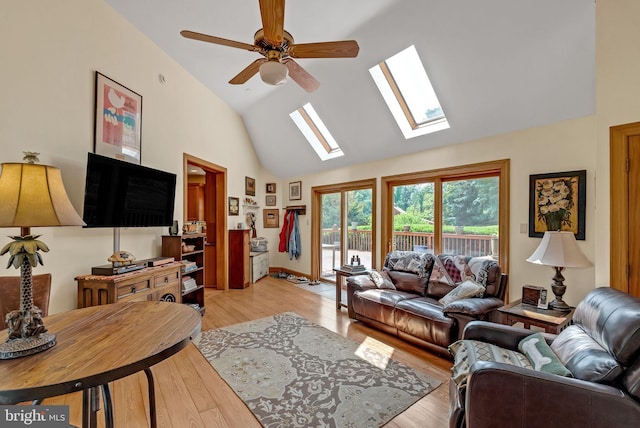 living room featuring light hardwood / wood-style floors, high vaulted ceiling, and ceiling fan