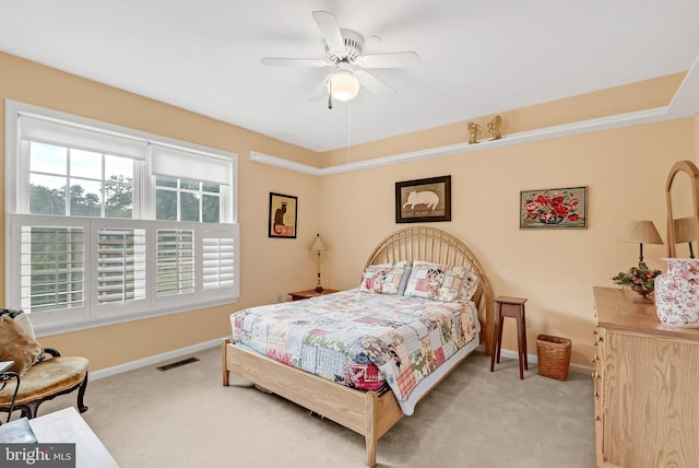 bedroom with light colored carpet and ceiling fan