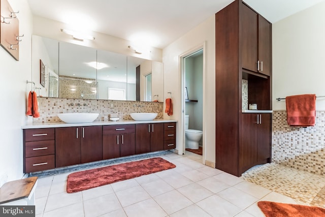 bathroom with walk in shower, tile patterned flooring, backsplash, toilet, and vanity