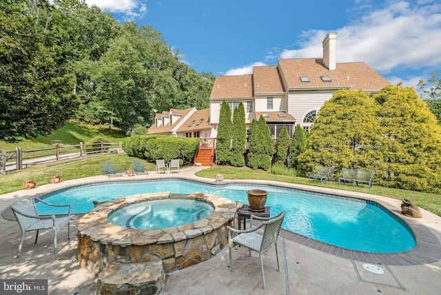 view of swimming pool with an in ground hot tub, a patio area, and a lawn