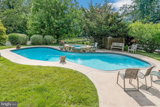 view of swimming pool featuring a patio area, an in ground hot tub, and a yard