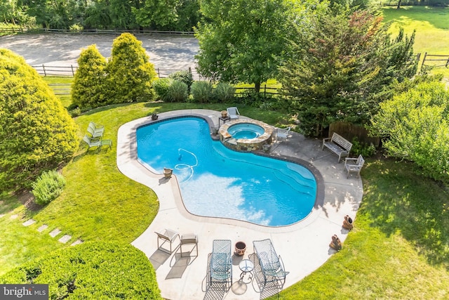 view of swimming pool featuring a patio area, an in ground hot tub, and a yard