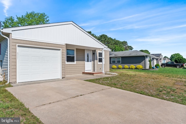 ranch-style home with a front yard and a garage