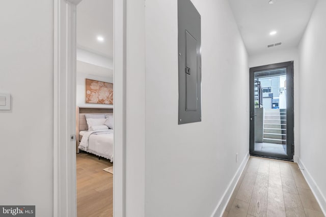 corridor with light hardwood / wood-style floors