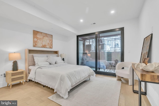 bedroom with access to exterior and light wood-type flooring