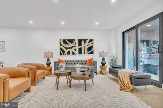 living room with a healthy amount of sunlight and light hardwood / wood-style floors