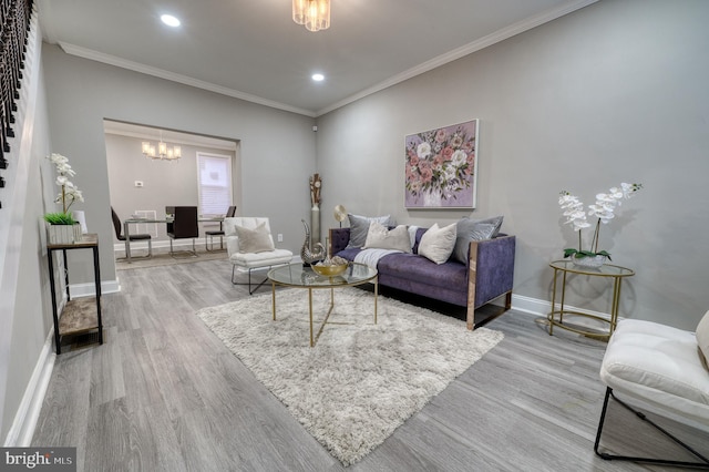 living room with crown molding, a chandelier, and hardwood / wood-style flooring