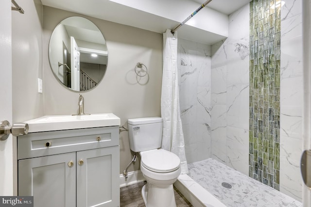 bathroom with vanity, hardwood / wood-style flooring, toilet, and curtained shower