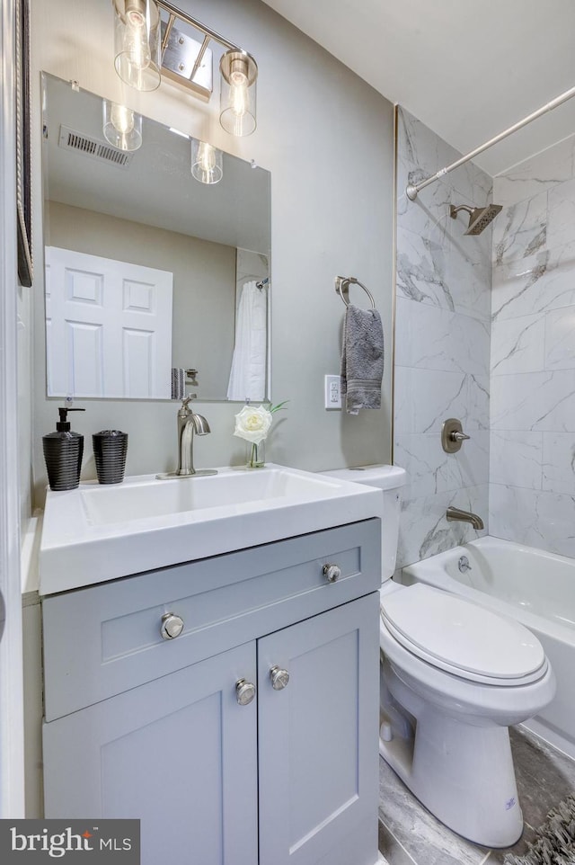 full bathroom featuring vanity, toilet, and tiled shower / bath