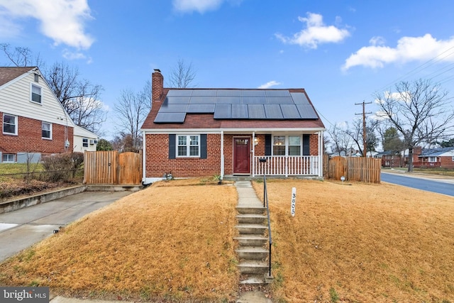 bungalow-style house featuring solar panels and covered porch