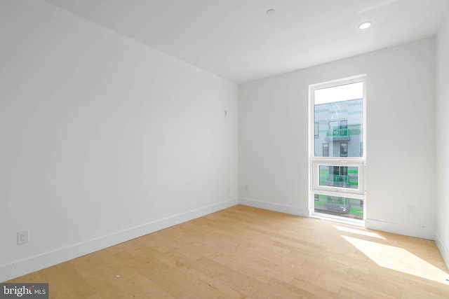 spare room with light hardwood / wood-style floors