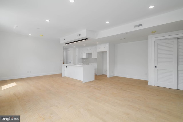 unfurnished living room with light hardwood / wood-style flooring