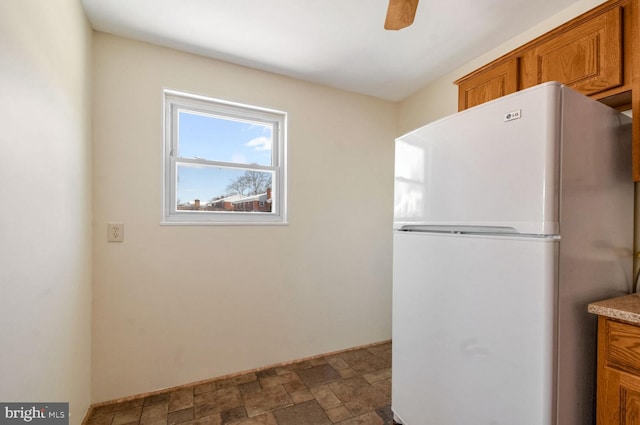 kitchen with ceiling fan and white fridge