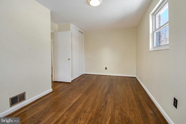 empty room with dark hardwood / wood-style floors