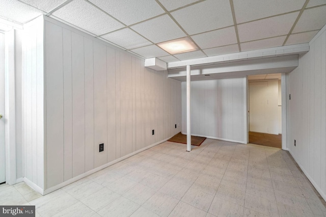 basement featuring a paneled ceiling