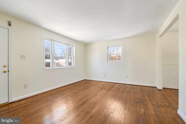 spare room featuring hardwood / wood-style floors and plenty of natural light