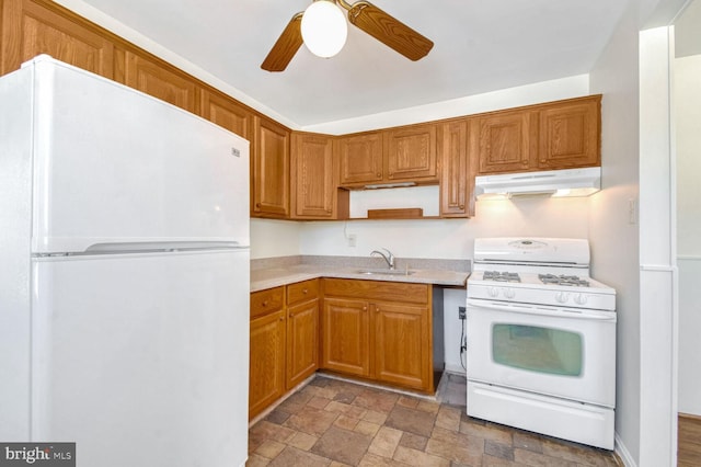 kitchen featuring ceiling fan, sink, and white appliances