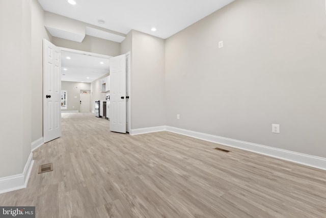 unfurnished room with light wood-type flooring