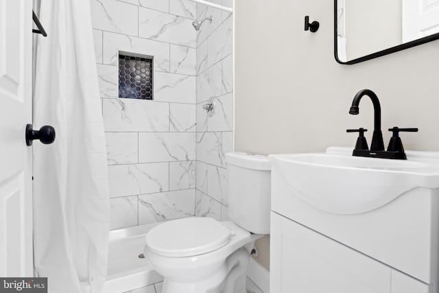 bathroom with tile patterned floors, vanity, toilet, and walk in shower