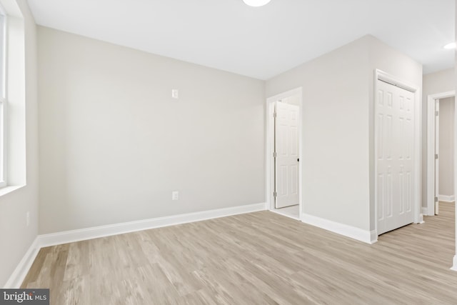 unfurnished room with light wood-type flooring