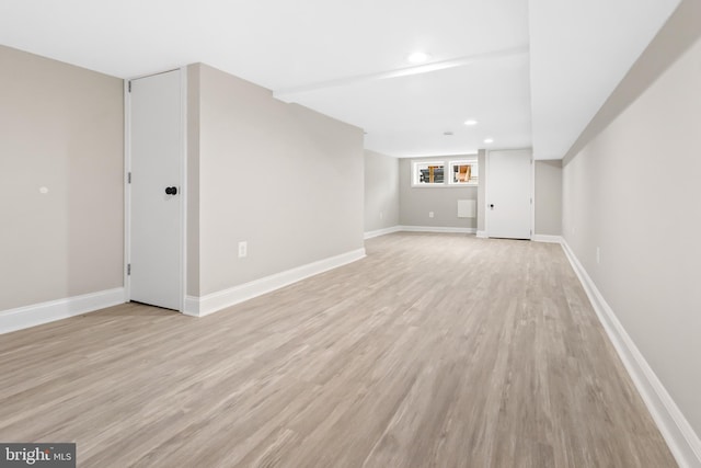 basement with light hardwood / wood-style floors