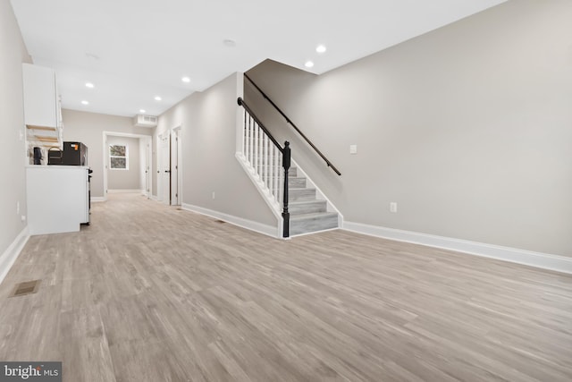 unfurnished living room with light hardwood / wood-style flooring