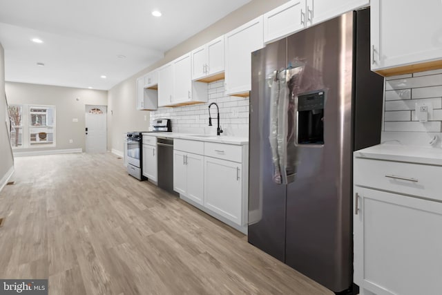 kitchen featuring white cabinets, stainless steel appliances, and sink