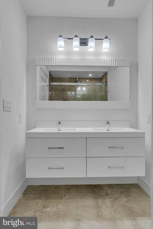 bathroom featuring vanity and a shower with shower door