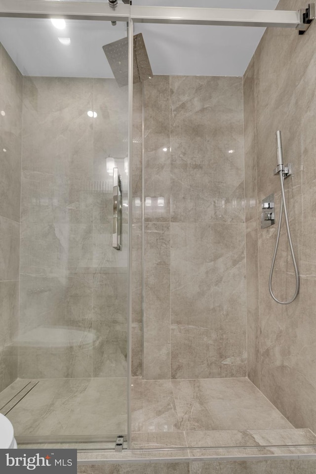 bathroom with a shower with shower door