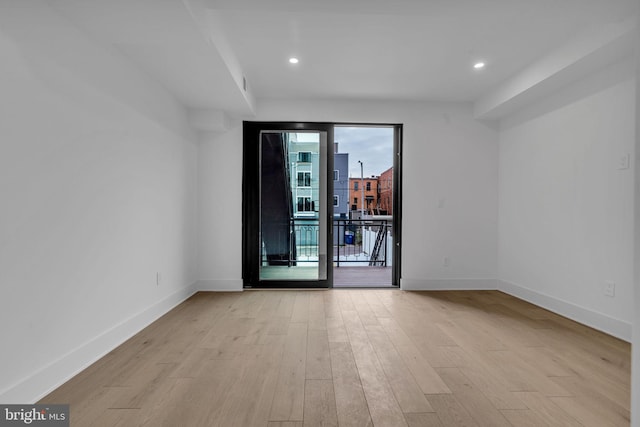 empty room with light hardwood / wood-style floors