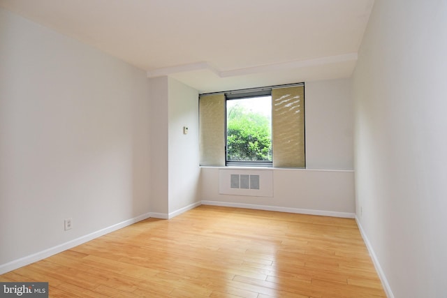 spare room featuring light hardwood / wood-style floors