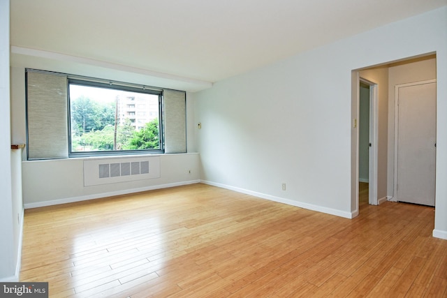 spare room featuring light hardwood / wood-style floors