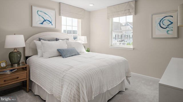 carpeted bedroom with multiple windows