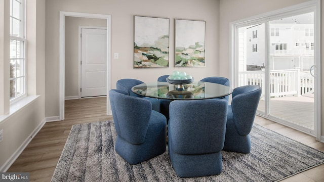 dining area featuring plenty of natural light and light hardwood / wood-style flooring