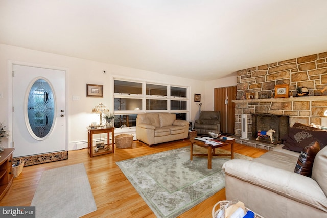 living room with a fireplace, hardwood / wood-style flooring, and a baseboard radiator