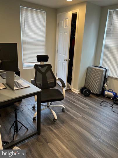 office space with dark hardwood / wood-style flooring