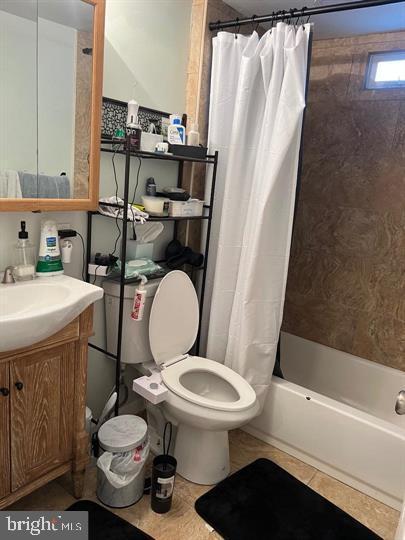 full bathroom with toilet, vanity, tile patterned floors, and shower / bathtub combination with curtain