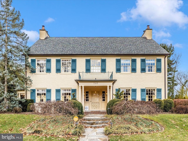 colonial-style house with a balcony