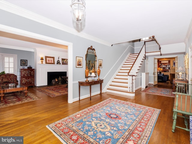 entryway featuring dark hardwood / wood-style flooring and ornamental molding