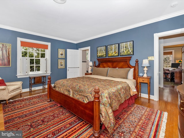 bedroom with hardwood / wood-style floors and ornamental molding