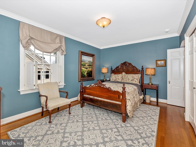 bedroom with crown molding and hardwood / wood-style flooring