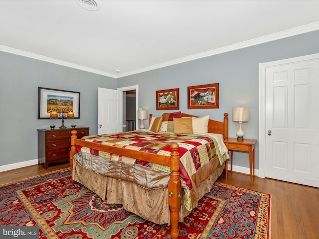 bedroom featuring wood-type flooring and ornamental molding