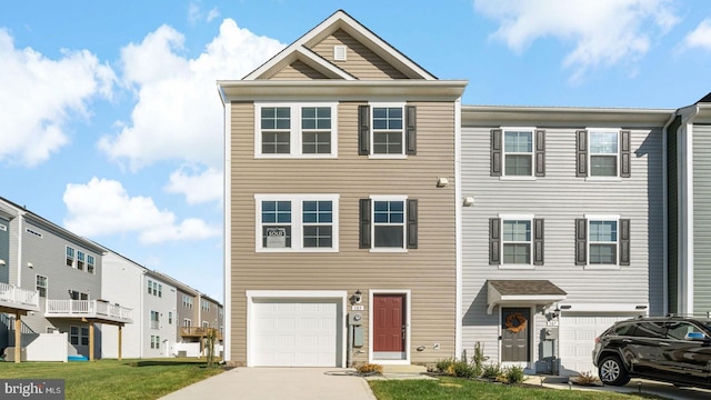 townhome / multi-family property featuring a front lawn and a garage