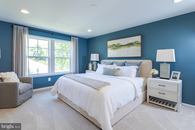 bedroom featuring light carpet