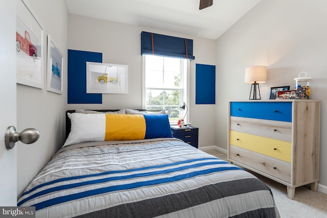 carpeted bedroom featuring ceiling fan and lofted ceiling