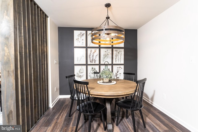 dining room featuring dark hardwood / wood-style floors and an inviting chandelier