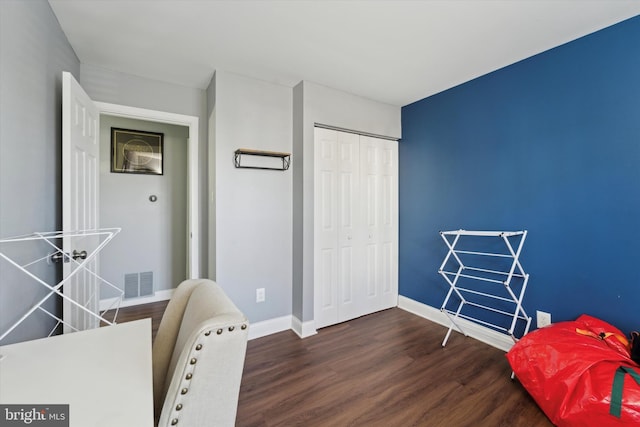 interior space with dark hardwood / wood-style floors and a closet