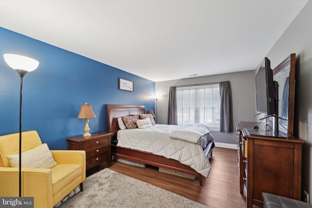 bedroom with dark wood-type flooring