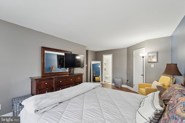 bedroom featuring ensuite bath and light hardwood / wood-style flooring